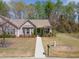 An aerial shot shows a home in a peaceful neighborhood setting, surrounded by mature trees and lawns at 469 Winding Wood Dr, Clayton, NC 27520