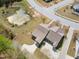 Aerial view shows lush landscaping, pond, and street layout of the neighborhood with well maintained lawn at 469 Winding Wood Dr, Clayton, NC 27520