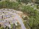 Aerial view of a community featuring green spaces, mature trees, and homes along winding streets at 469 Winding Wood Dr, Clayton, NC 27520