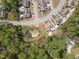 Aerial view displaying homes with lush trees, a pond, and manicured lawns nestled in a well-planned neighborhood at 469 Winding Wood Dr, Clayton, NC 27520