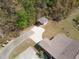 Aerial view of home featuring a separate building with driveway, situated among lush green trees at 469 Winding Wood Dr, Clayton, NC 27520