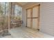 Inviting back porch featuring a wooden swing and double doors, perfect for relaxing outdoors at 469 Winding Wood Dr, Clayton, NC 27520