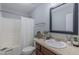 A bathroom featuring a single sink vanity, a large mirror, and a shower/tub combo at 469 Winding Wood Dr, Clayton, NC 27520