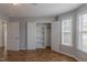 A bedroom with natural light, an open closet with shelving, and wood flooring at 469 Winding Wood Dr, Clayton, NC 27520