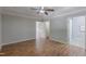 A spacious bedroom with a tray ceiling, natural light, and wood floors with an ensuite bathroom at 469 Winding Wood Dr, Clayton, NC 27520