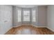 A bright bedroom with bay windows, a double door closet, and wood flooring at 469 Winding Wood Dr, Clayton, NC 27520