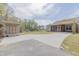 View of a one-story home featuring a long concrete driveway and screened in back porch at 469 Winding Wood Dr, Clayton, NC 27520