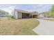 Exterior view of a home with a well-maintained lawn, driveway, and a screened-in porch at 469 Winding Wood Dr, Clayton, NC 27520