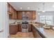 Well-equipped kitchen with stainless steel appliances, dark wood cabinets, and laminate countertops at 469 Winding Wood Dr, Clayton, NC 27520