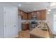 A corner kitchen features stainless steel appliances, wood cabinets, and a double sink with pendant lighting at 469 Winding Wood Dr, Clayton, NC 27520