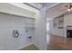 A clean and bright laundry room with washer and dryer hookups, shelving, and tile flooring at 469 Winding Wood Dr, Clayton, NC 27520