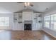 Inviting living room featuring built-in shelving, a cozy fireplace, and large windows for natural light at 469 Winding Wood Dr, Clayton, NC 27520