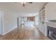 Open-concept living room with a view of the kitchen, featuring wood floors and a fireplace at 469 Winding Wood Dr, Clayton, NC 27520