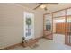 Covered porch with an outdoor ceiling fan, and decorated with a wreath, doormat and potted plant at 469 Winding Wood Dr, Clayton, NC 27520