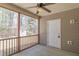 Screened porch with an outdoor ceiling fan overlooking a large backyard and storage shed at 469 Winding Wood Dr, Clayton, NC 27520
