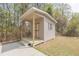 Exterior shot of a storage shed with double doors and swing on the front porch at 469 Winding Wood Dr, Clayton, NC 27520