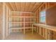 Well-lit storage room boasts wooden construction and includes built-in shelving for organization and efficiency at 469 Winding Wood Dr, Clayton, NC 27520
