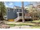 Two-story home with a wooden deck, steps down to the yard, and light-blue siding at 4725 Sinclair Dr, Raleigh, NC 27616
