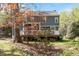 Backyard view of the home, featuring a wooden deck and mature trees at 4725 Sinclair Dr, Raleigh, NC 27616