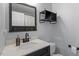 Bathroom with dark wood framed mirror, white countertop and dark wood vanity cabinet at 4725 Sinclair Dr, Raleigh, NC 27616