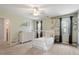 Cozy bedroom features a custom tree mural, neutral paint and carpet and white wood furniture at 4725 Sinclair Dr, Raleigh, NC 27616