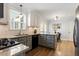 Modern kitchen with granite countertops, gray cabinets, updated appliances, and eat in area at 4725 Sinclair Dr, Raleigh, NC 27616
