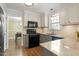 Well-lit kitchen with gray cabinets, stylish backsplash, granite countertops, and stainless appliances at 4725 Sinclair Dr, Raleigh, NC 27616