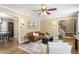 Inviting living room featuring an open layout, wood floors and access to dining room and stairs at 4725 Sinclair Dr, Raleigh, NC 27616