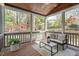 Screened in porch with a wooded ceiling and comfortable seating at 4725 Sinclair Dr, Raleigh, NC 27616