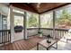 View of the backyard from the screened in porch with wooded ceiling and outdoor furniture at 4725 Sinclair Dr, Raleigh, NC 27616