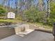 Backyard patio with shed and wooded area at 4818 Glendarion Dr, Durham, NC 27713