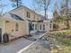 Exterior rear elevation with a patio, a well manicured lawn, mature trees, and a gravel drainage feature at 4818 Glendarion Dr, Durham, NC 27713