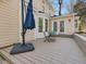 Spacious backyard with a wood deck, outdoor seating, an umbrella, and mature trees at 4818 Glendarion Dr, Durham, NC 27713
