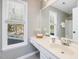 Bathroom features a vanity with sink, a large mirror, and a window with natural light at 4818 Glendarion Dr, Durham, NC 27713