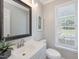 Powder room with vanity, mirror, and natural light at 4818 Glendarion Dr, Durham, NC 27713