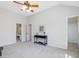 Bedroom with neutral walls, plush carpet, ceiling fan, and a decorative table at 4818 Glendarion Dr, Durham, NC 27713