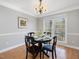 This dining room features a hardwood floor, a decorative chandelier and lots of natural light at 4818 Glendarion Dr, Durham, NC 27713