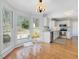 Eat-in kitchen area with stainless appliances, white cabinetry and hardwood floors at 4818 Glendarion Dr, Durham, NC 27713