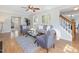 Comfortable living room with hardwood floors, neutral paint, modern ceiling fan, and decorative furniture at 4818 Glendarion Dr, Durham, NC 27713
