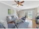 Sunlit living room features hardwood floors, comfortable seating, and a view of the entry and staircase at 4818 Glendarion Dr, Durham, NC 27713