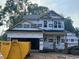 New two-story home under construction featuring a covered front porch and an attached two-car garage at 49 Fetterbush Way, Clayton, NC 27520