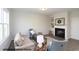 Comfortable living room featuring a fireplace, built-in shelves, couch, and a modern decor at 49 Fetterbush Way, Clayton, NC 27520