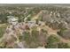 Overhead shot showcasing the community clubhouse, golf course, parking, and surrounding trees at 5220 Linksland Dr, Holly Springs, NC 27540