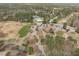 Community aerial view showing a golf course, clubhouse, pool, tennis courts, and surrounding neighborhood at 5220 Linksland Dr, Holly Springs, NC 27540