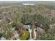 An elevated view reveals the home nestled among verdant trees, complemented by a private pool and expansive grounds at 5220 Linksland Dr, Holly Springs, NC 27540