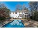 The exterior back boasts an inviting swimming pool, stylish patio furniture, and a cozy screened-in porch at 5220 Linksland Dr, Holly Springs, NC 27540