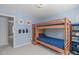 Bright bedroom featuring bunk beds, carpet, and neutral walls at 5220 Linksland Dr, Holly Springs, NC 27540