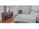 Relaxing bedroom with warm wood floors, dresser, and large window at 5220 Linksland Dr, Holly Springs, NC 27540
