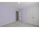 Bedroom featuring lilac walls, carpet, and closet doors at 5220 Linksland Dr, Holly Springs, NC 27540