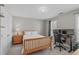Cozy bedroom with a wood frame bed, desk area and natural light at 5220 Linksland Dr, Holly Springs, NC 27540